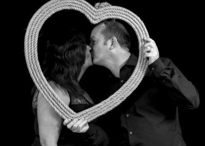 Photobooth kiss in a heart frame