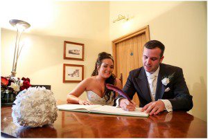 Bride and groom signing the register