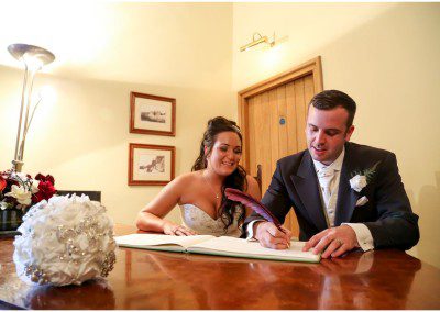 Bride and groom signing the register
