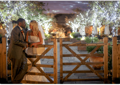 A bride and groom resting on the gate